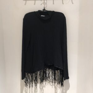 Red haute black mock-neck w/ fringe